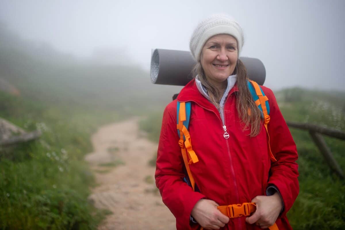 a portrait of an elderly woman hiking