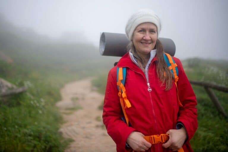 a portrait of an elderly woman hiking