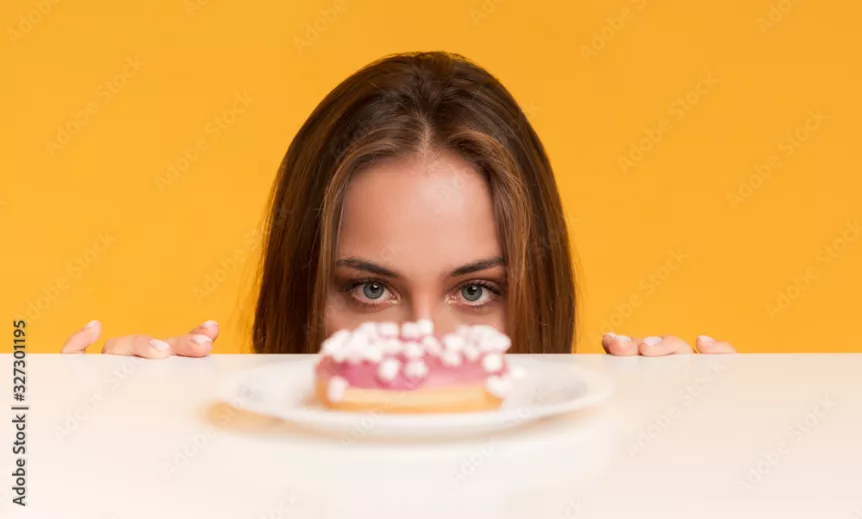 Hungry Woman Peeking Out Of Table Starving To Eat Donut