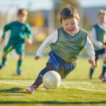 Portrait of a Child with Down Syndrome playing soccer