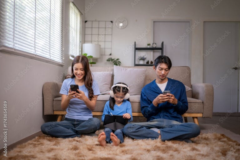 Family members using digital devices in living room