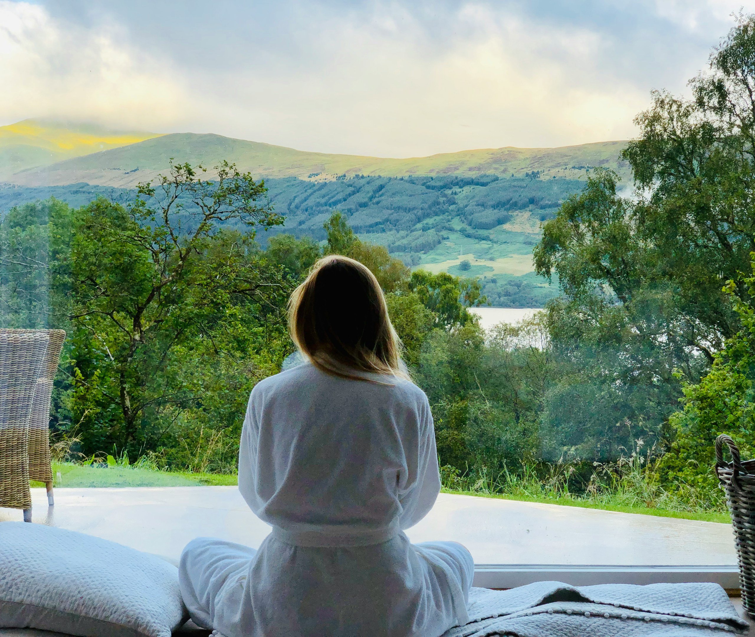 Sitting woman in white robe looking at mountains during daytime stockpack unsplash